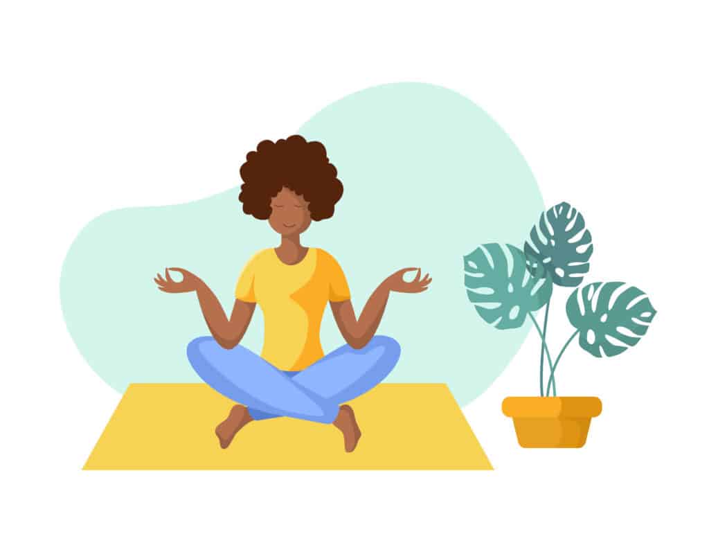 Young African American woman meditating with legs crossed and hands at her side pinching her fingers together